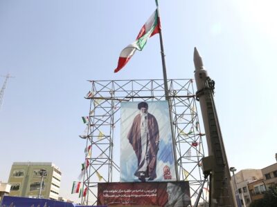 Sebuah sistem rudal Iran dipamerkan di samping spanduk dengan gambar Pemimpin Tertinggi Iran, Ayatollah Ali Khamenei, dan mendiang pemimpin Hezbollah Lebanon, Hassan Nasrallah, di sebuah jalan di Teheran, Iran, pada 2 Oktober 2024. Majid Asgaripour/WANA (West Asia News Agency) via REUTERS.